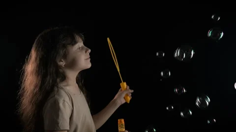 Child play with bubbles in dark room. Stock Footage 269077206