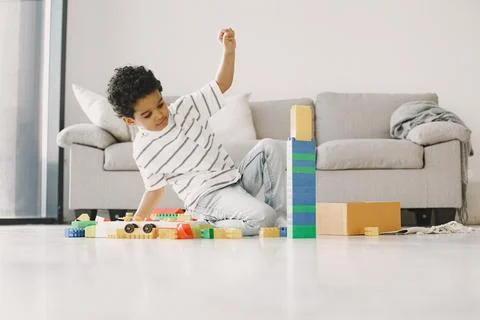 Child play with a colored constructor on floor Stock Photos