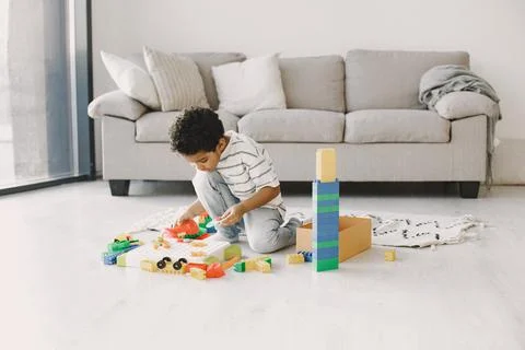 Child play with a colored constructor on floor Stock Photos