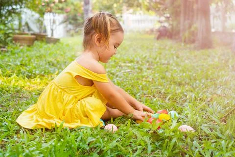 Child play Easter eggs hunting in the backyard Stock Photos