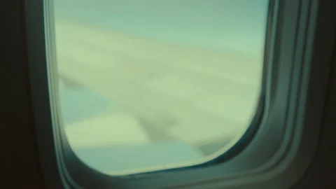 Child play with paper plane inside airplane in air Stock Footage