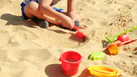 Child play in the sandbox. Boy is digging shovel sand 스톡 동영상 94547431