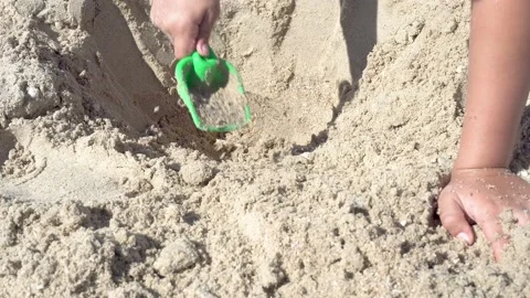 Child play in the sandbox. Boy is digging shovel sand Stockbeeldmateriaal 133804540
