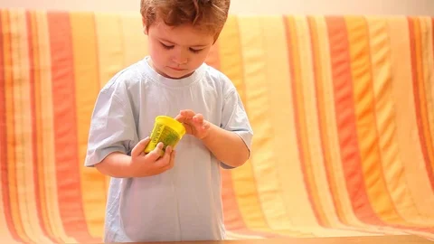 Child is played with plasticine. Developing game and entertainment at home Stock Footage 94427394