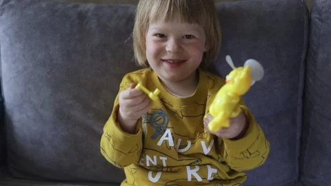 A child playing accidentally breaks a toy and laughs merrily Video stock 239783288