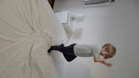 Child playing and jumping on bed Stock Footage 316245160