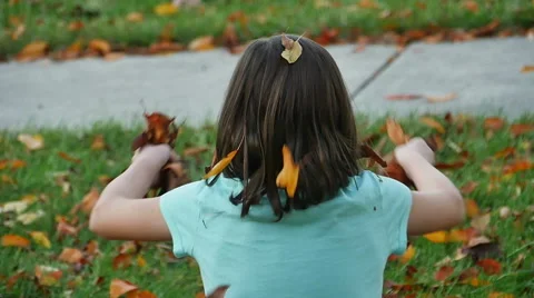 Child Playing and Throwing Leaves in Air in Slow Motion Stock Footage 56687014