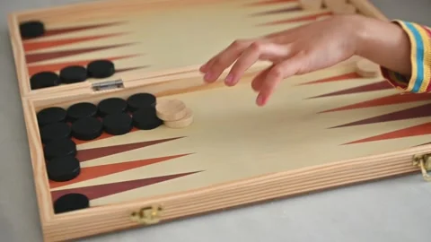 Child playing backgammon with colorful striped sweater Stock Footage 290051016