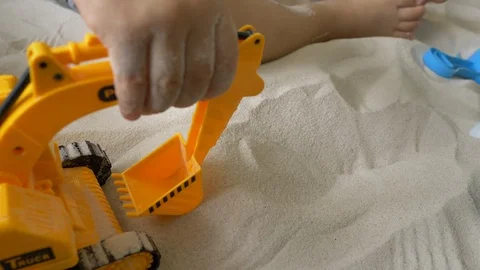 Child playing backhoe loader excavator toy in sand playground Stock Footage 109500087
