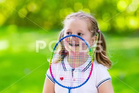 Child playing badminton or tennis outdoor in summer Stock Photos