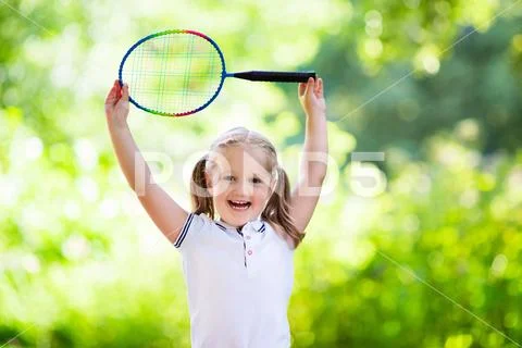 Child playing badminton or tennis outdoor in summer Stock Photos