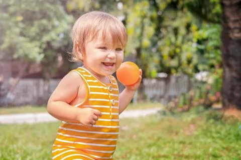 The child is playing with the ball. Stock Photos