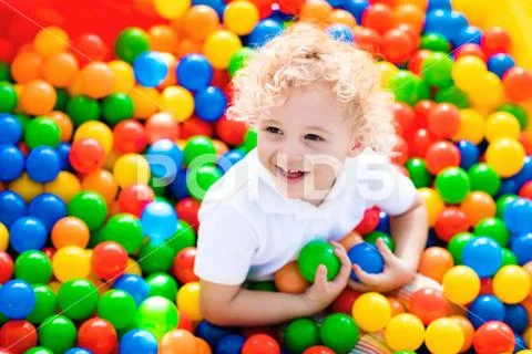 Child playing in ball pit on indoor playground Stock Photos