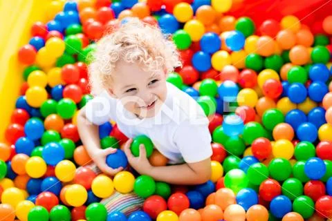 Child playing in ball pit on indoor playground Stock Photos