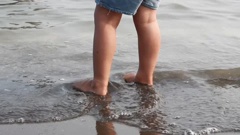 A child is playing on the beach Stock Footage 240908435