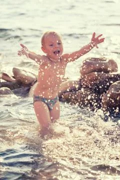 Child playing on the beach Stock Photos