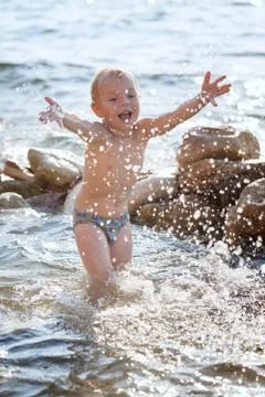 Child playing on the beach Stock Photos