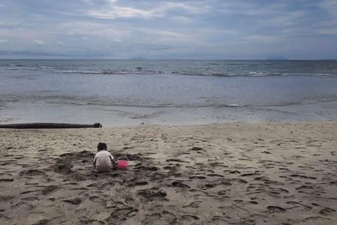 A child is playing on the beach Stock Photos