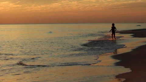 Child Playing on Beach at Sunset Video stock 41457197