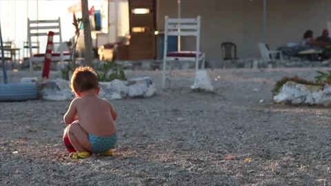 Child playing at the beach. Toddler plays with ball. Childhood concept. Stock Footage 145255672