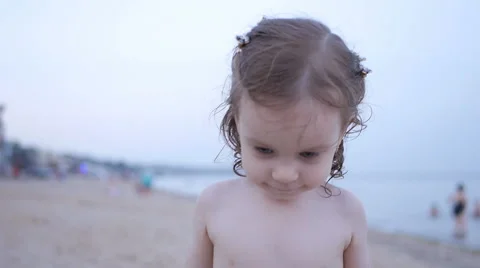 Child Playing on the Beach while Father Show how Sand Pours from Hands Stock Footage 65526607