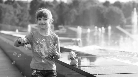 The child is playing - blowing bubbles. Stock Footage 80084282