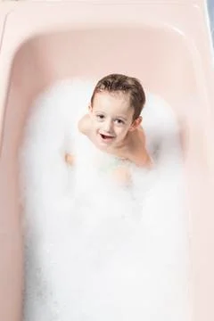 Child playing in a bubble bath Stock Photos