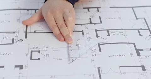 The child is playing with builders drawing  Stock Footage 240570084