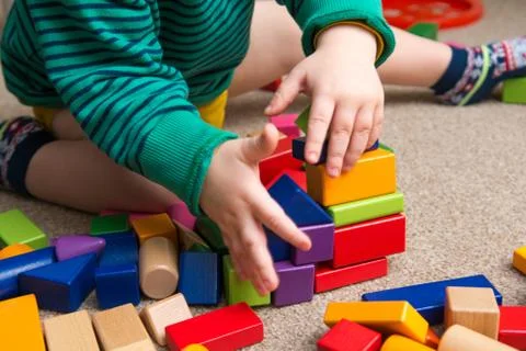 Child playing with building blocks learning new skills Stock Photos