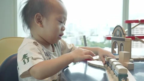 Child Playing with Building Blocks in Urban Setting Stock Footage 343556669