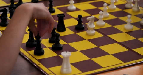 Child is playing chess. Hand moves the black pawn. Stock Footage 277611263
