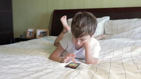 Child playing chess on mobile device Stock Footage 158786185