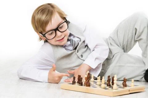 Child Playing Chess, Smart Kid Boy in Business Suit Glasses play Chessboard Stock Photos