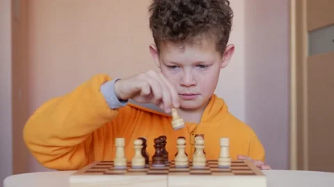Child playing chess at table Stock Footage 149198649