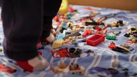 A child playing in the children's designer on the bed Stock Footage 106482083