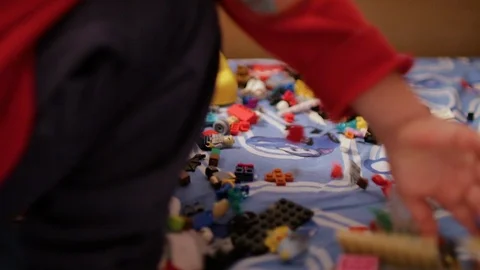 A child playing in the children's designer on the bed Stock Footage 106494876