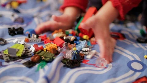 A child playing in the children's designer on the bed Stock Footage 106508262