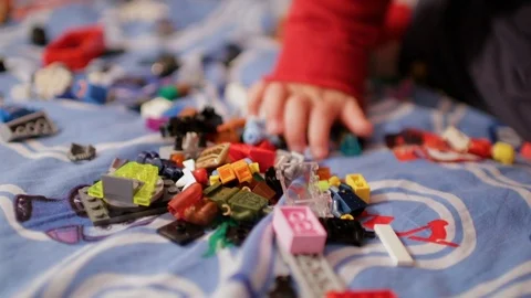 A child playing in the children's designer on the bed Stock Footage 106515650