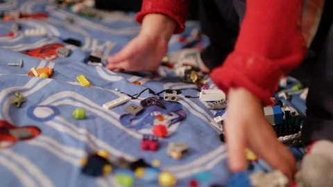 A child playing in the children's designer on the bed Stock Footage 106545189