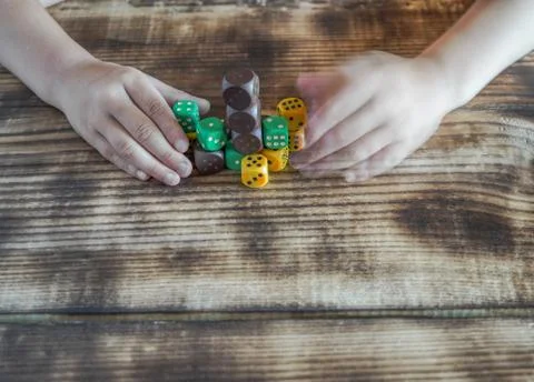 The child is playing with colored cubes Stock Photos
