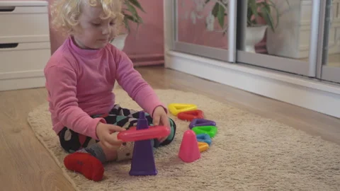 Child playing with a colored pyramid Stock Footage 292484037