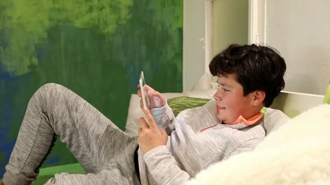 Child playing computer game on digital tablet in the home 3 Stock Footage 103318306