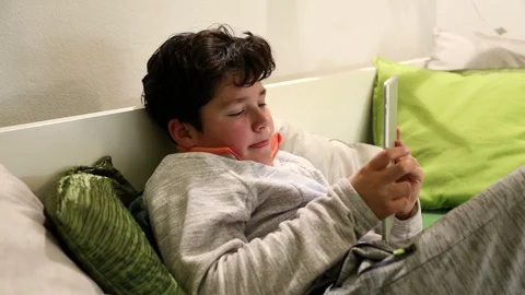 Child playing computer game on digital tablet in the home 5 Stock Footage 103318696