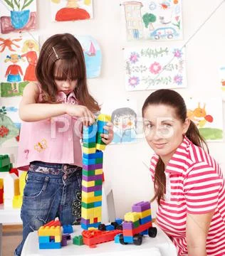 Child playing construction set with mother. Stock Photos
