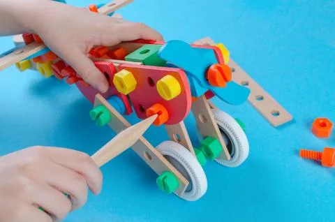 Child playing with constructor and make a plain, closeup Stock Photos