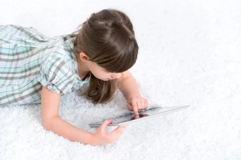 Child playing with digital tablet Stock Photos