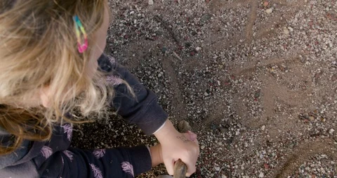 Child playing in the dirt with a stick Video stock 128804979