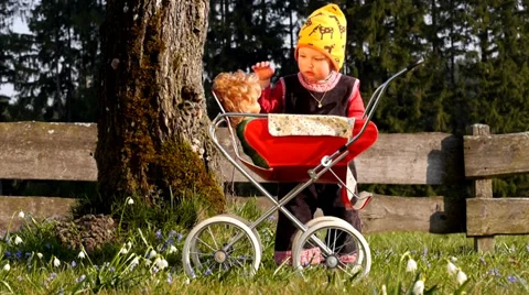Child playing with doll carriage Stock Footage 36670958