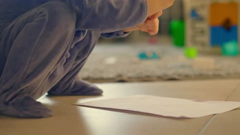 Child playing drawing sitting on the floor Stock Footage 200124582
