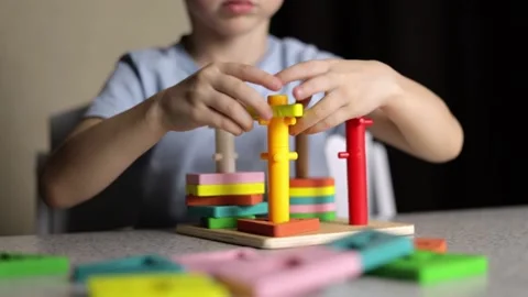 The child is playing with an educational toy Stock Footage 232570144